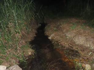 A stream in a dark area

Description automatically generated